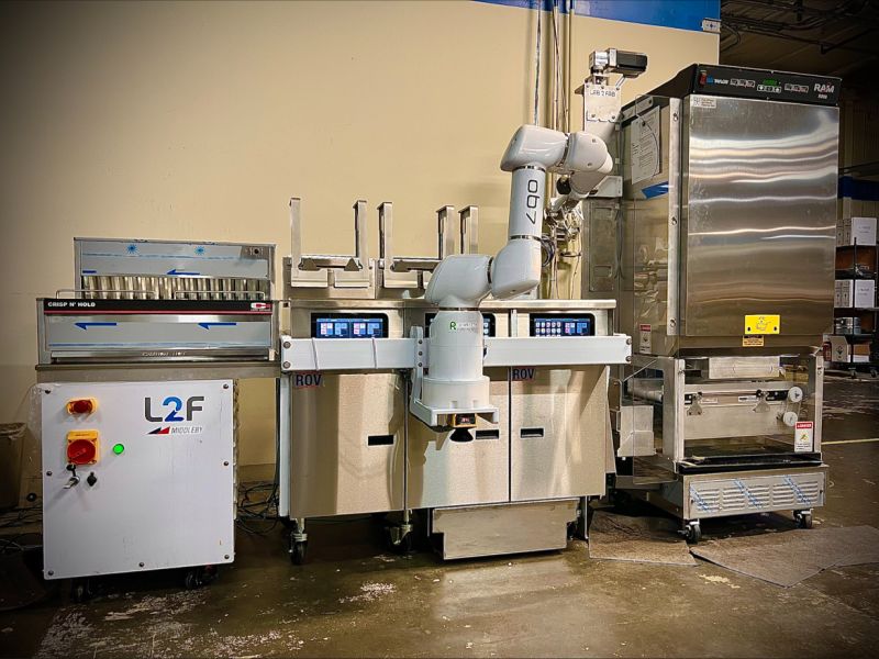 Lab2Fab (Middleby) robotic fry station: a robot arm between commercial fryers, with a Crisp N' Hold holding station and an automated RAM frozen-product dispenser