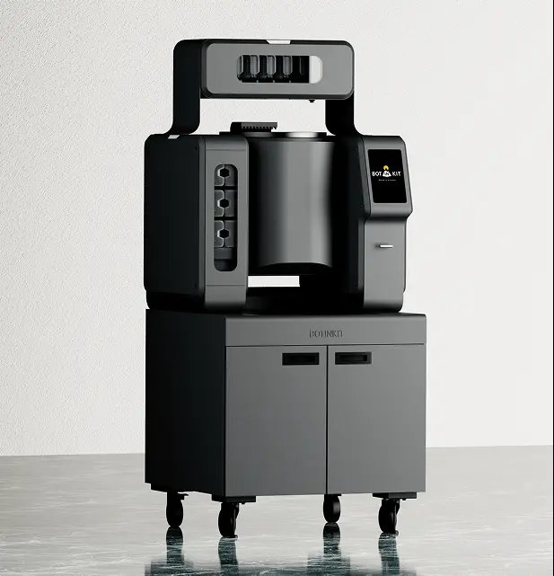 Botinkit OMNI cooking robot: a black countertop wok-cooking unit with ingredient dispensers and a touchscreen, on a wheeled base cabinet