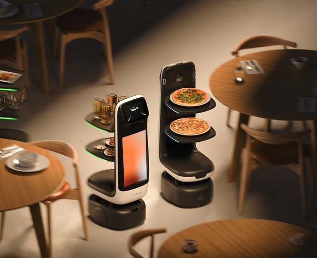 Two Bear Robotics Servi Q service robots carrying pizzas and drinks between restaurant tables