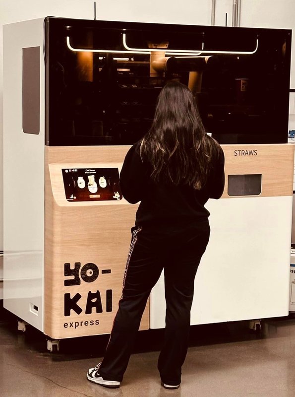 Yo-Kai Express ramen vending kiosk with a customer ordering at its screen